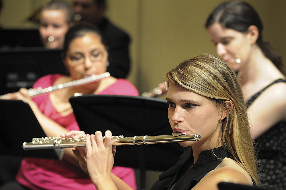 Photo of flute player performing among other band members