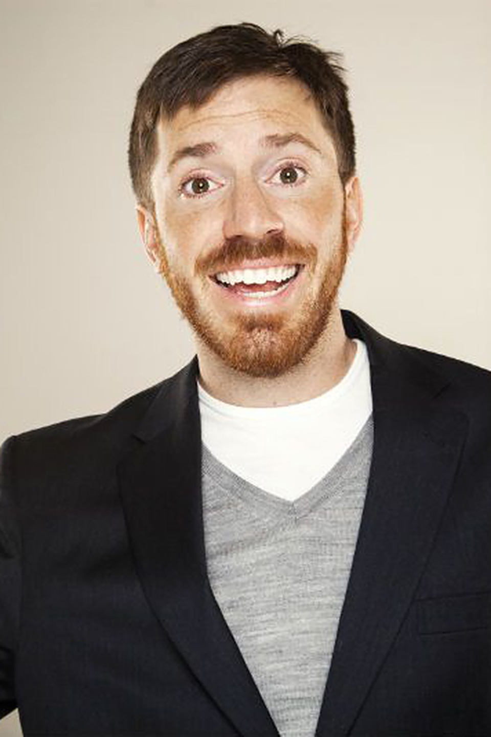 Joe Zimmerman smiles for the camera against a light backdrop