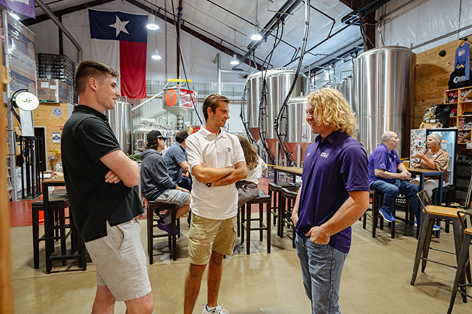 People networking at a brewery