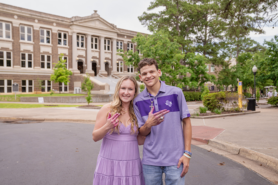 Two students hold up their Axe 'em hand signs
