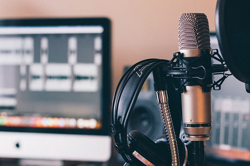 Photo of microphone, headphones in a studio