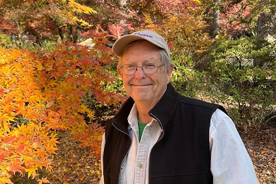 SFA Gardens Director Dr. David Creech is shown in front of bright orange foliage